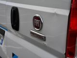 the back end of a white van with a fiat logo on it