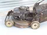 a lawn mower that is sitting on the ground