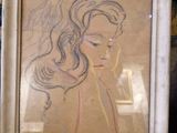 dessin représentant une femme aux cheveux longs, encadrée, allongée sur un canapé