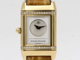 a close up of a gold watch with diamonds on the face