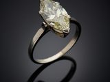 a yellow diamond ring with a pear shaped diamond in the center