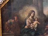 an old painting of a woman holding a child in her lap