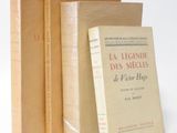 three books sitting on top of each other on a white surface