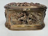 a silver box with a design of birds and flowers on it