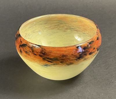 a yellow and orange bowl sitting on a table