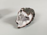 two pieces of white and black rock on a white surface
