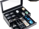a close up of a box with a watch and other items in it