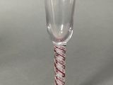 a wine glass with a red and white stripe on it