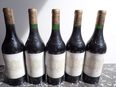 six bottles of wine are lined up on a table