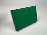 an image of a green felt board on a white surface