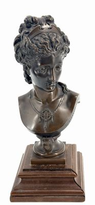 bronze bust of a woman on a wooden base on a white background