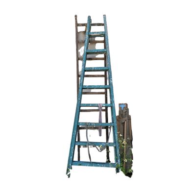 a blue ladder that is leaning against a white wall