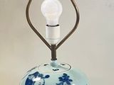 a blue and white lamp that is on a table