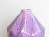a purple vase that is sitting on a table