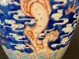 a blue vase with a picture of a woman on it