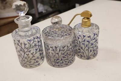three glass bottles with blue and white designs on them