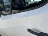 a white car with the door open and the driver ' s seat down