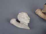 two figurines of a man and a dog on a table
