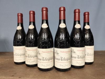 six bottles of red wine are lined up on a wooden table