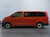 the red van is parked on the concrete floor in the room
