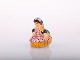 a figurine of a woman in a pink dress