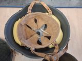 a helmet that is sitting in a bucket on a table