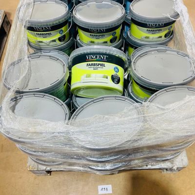 many cans of paint in a plastic container on a table