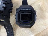 a close up of a watch and a watch on a table