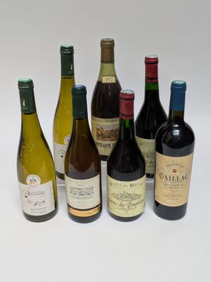 several bottles of wine are lined up in a row on a white surface