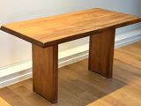 a wooden bench sitting on a hard wood floor