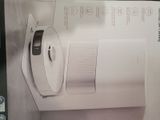 packaging of a white microwave sitting on top of a white box