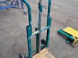 a hand truck that is sitting in the middle of a parking lot