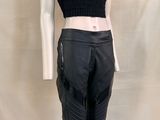 the mannequin is wearing black leather pants and a cropped top