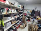 a room filled with lots of shoes and bags