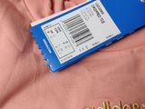 a pink shirt with a price tag attached to it