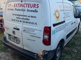 a van that is parked in the grass with other vehicles
