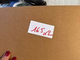 a person holding a brown box with a sticker on it