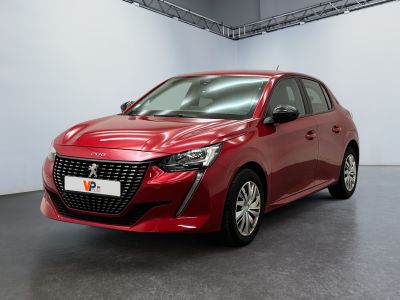 a red car parked in a large room with a white wall
