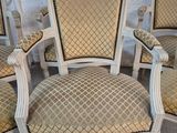four chairs with upholstered cushions and a matching arm rest