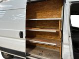 a white van with open doors and shelves in the back
