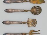 three spoons and a spatula are sitting on a white surface