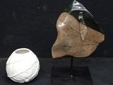 a white vase and a white vase on a black table