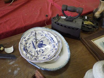 a wooden table topped with plates and a tea kettle