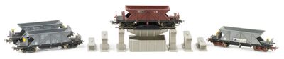 three toy trains sitting next to each other on a white surface