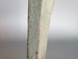 a stone sculpture on a wooden stand on a table