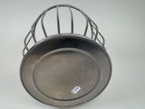 a metal pan with a wire basket on it
