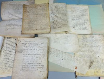 several old papers are stacked on top of each other on a table