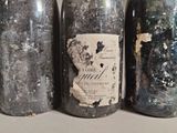 three bottles of wine that have been left on the table