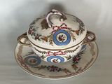 a bowl and saucer sitting on a saucer on a plate