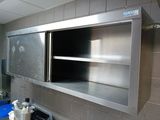a kitchen with stainless steel cabinets and a blue trash can